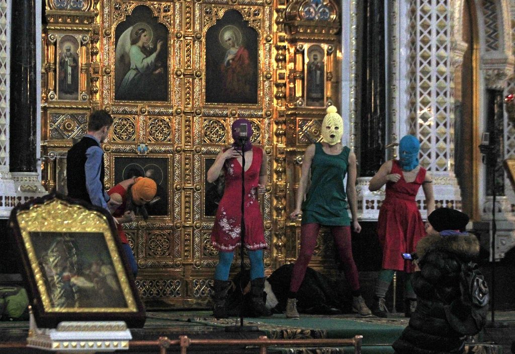 Members of the Russian radical feminist group Pussy Riot try to perform at the Christ the Saviour Cathedral in Moscow, 21 February 2012. (AP Photo/Sergey Ponomarev)